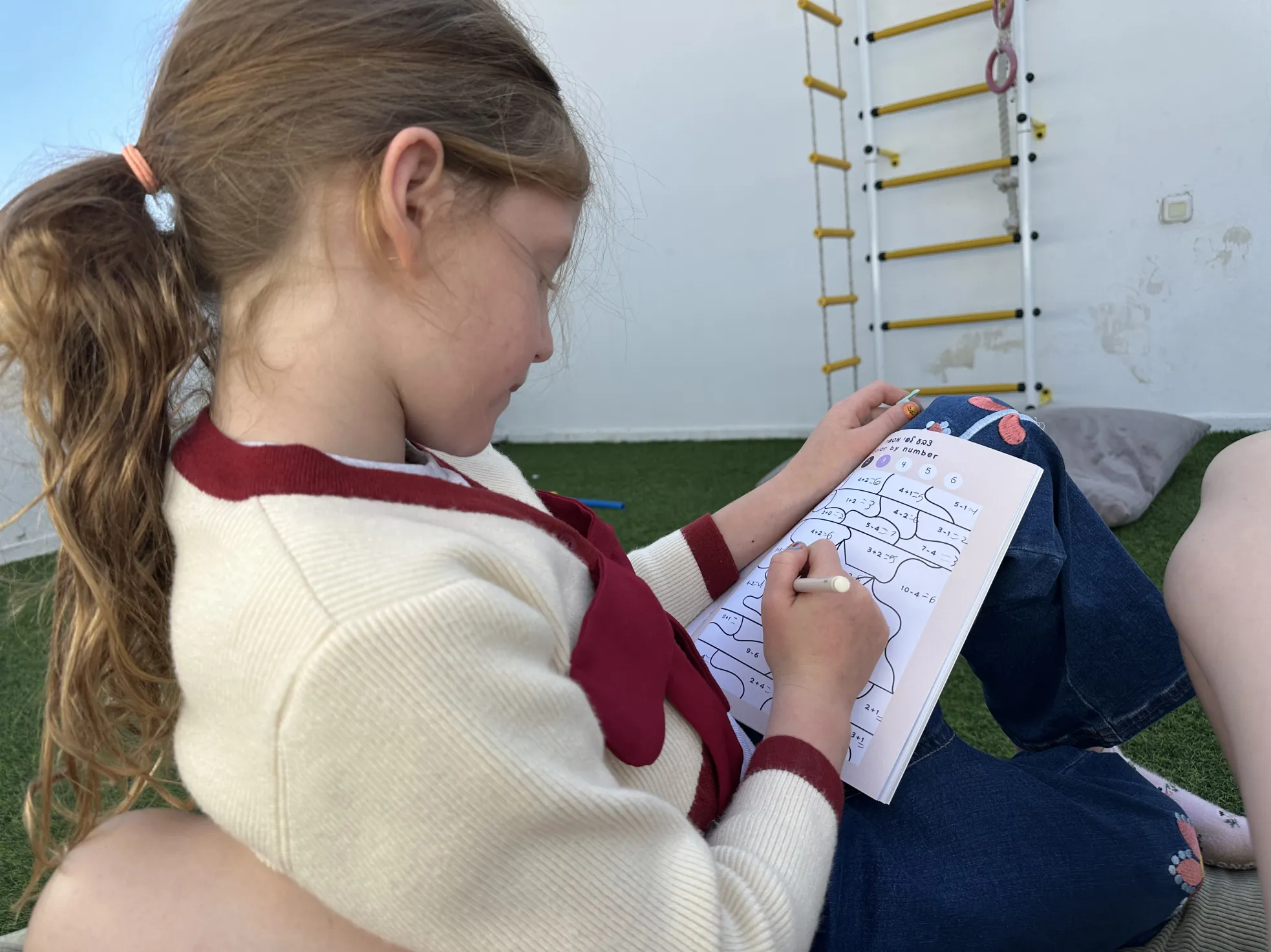 Girl coloring by number in the magazine